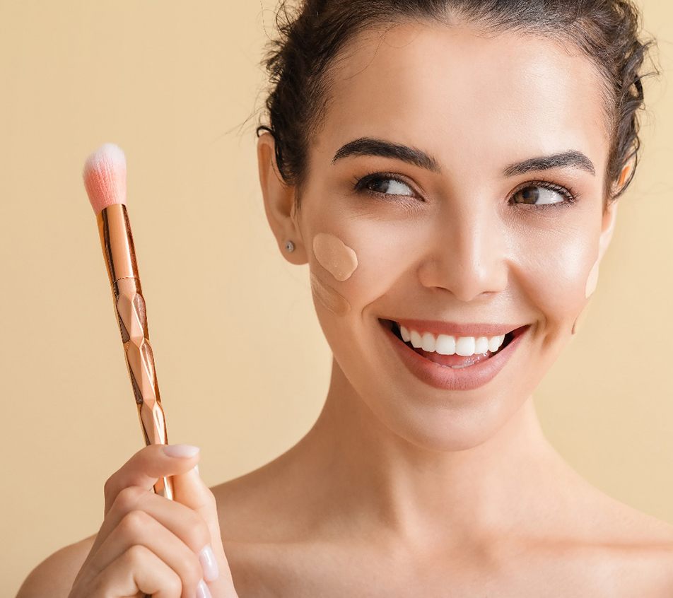Woman applying makeup, enjoying benefits of dermaplaning