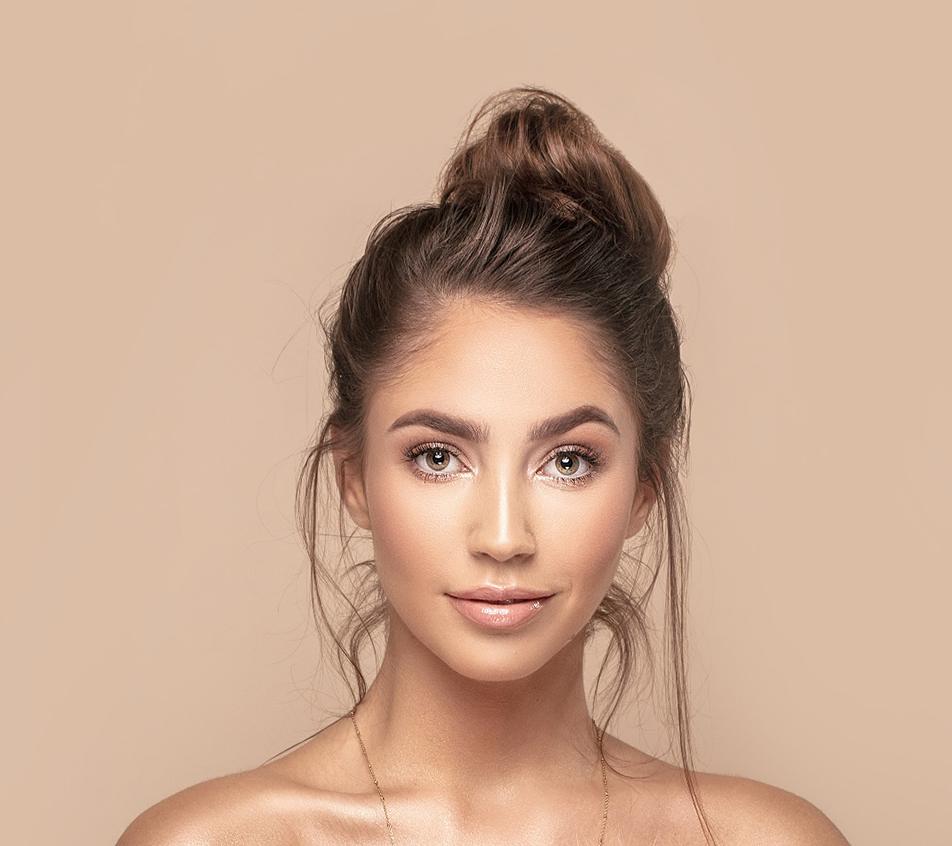 Portrait of young woman with beautiful skin against neutral background