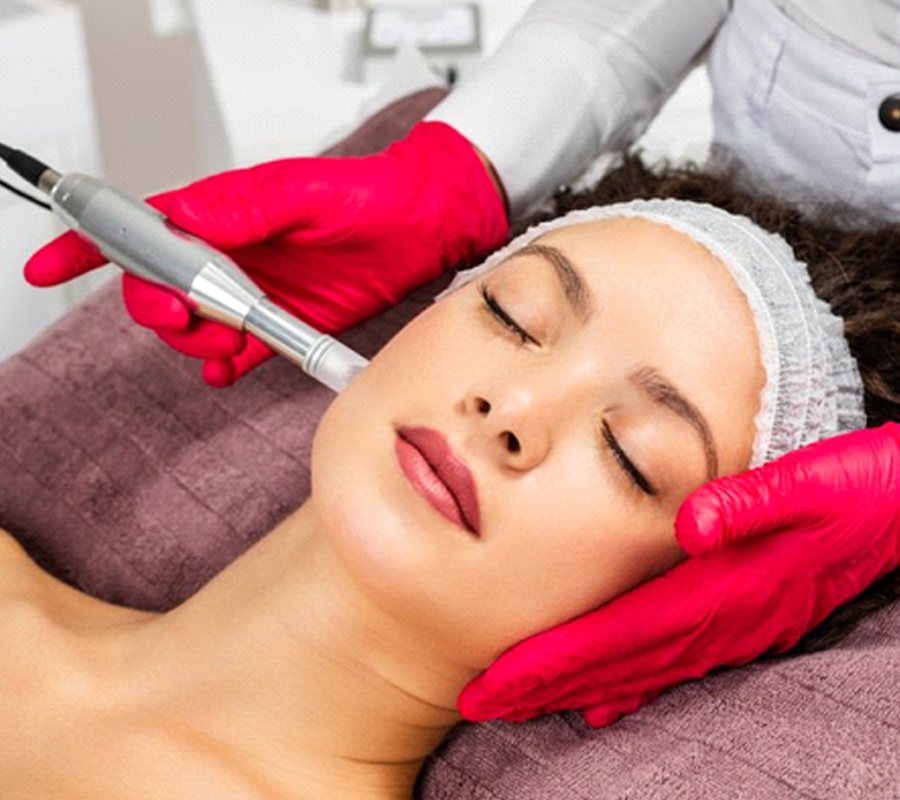 a person laying down and receiving micro-needling treatment