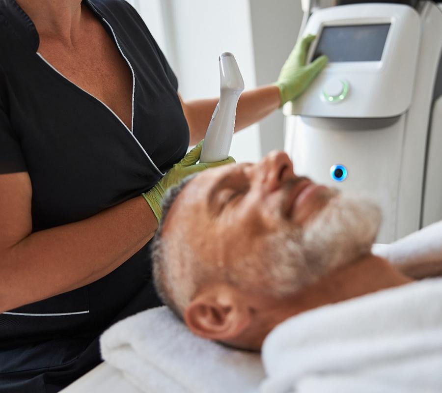 a person laying down on a treatment table getting ready to receive an IPL PhotoFacial