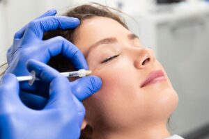 Woman receiving BOTOX injection near her eye