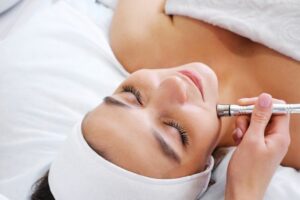 Woman relaxing while undergoing microdermabrasion treatment 