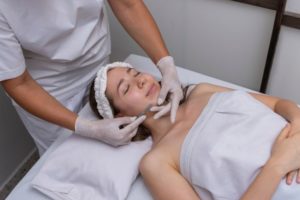 Woman relaxing during dermaplaning treatment
