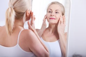 woman looking in mirror